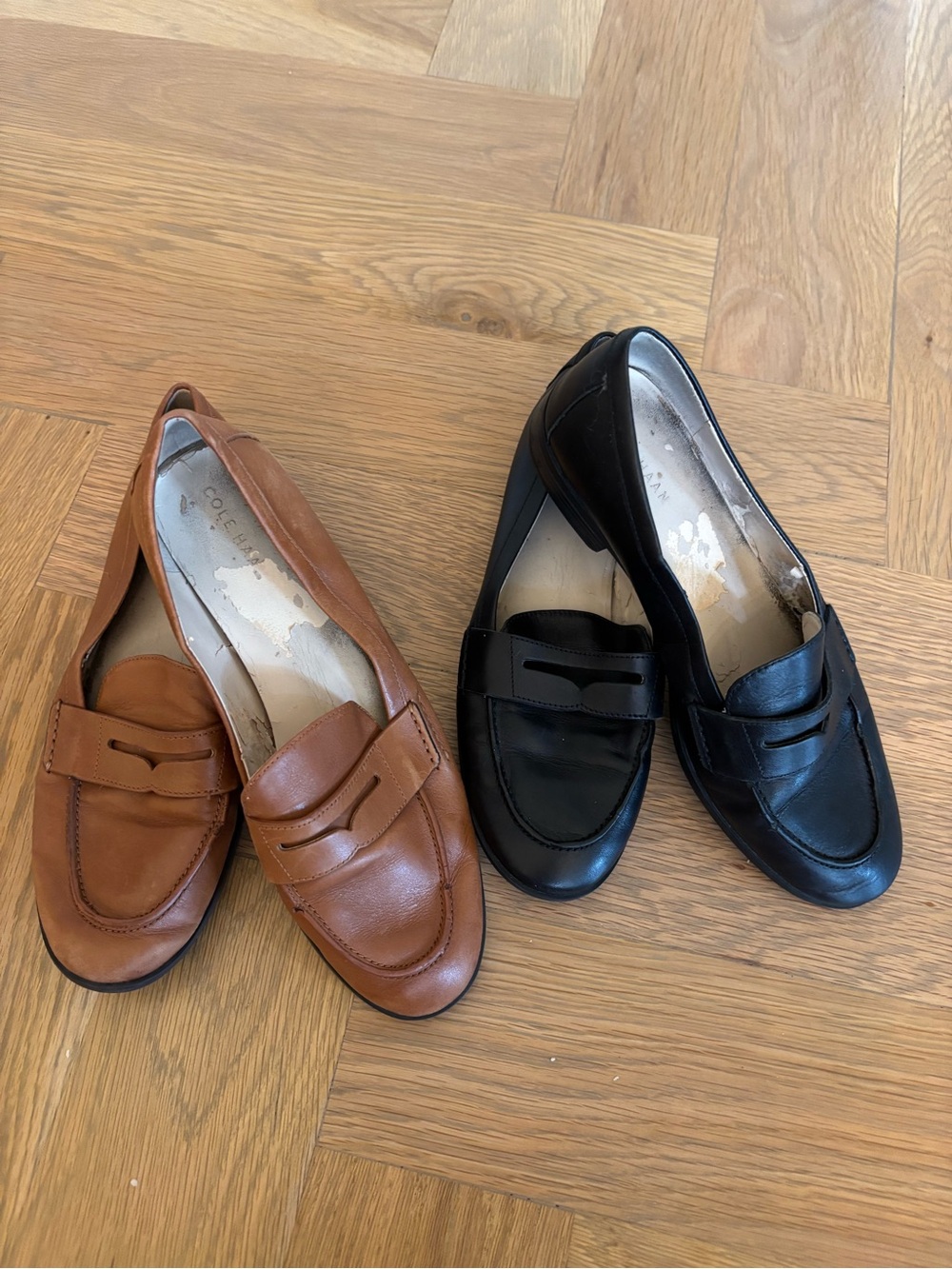Cole Haan penny loafers. Two pairs- tan leather and black leather.